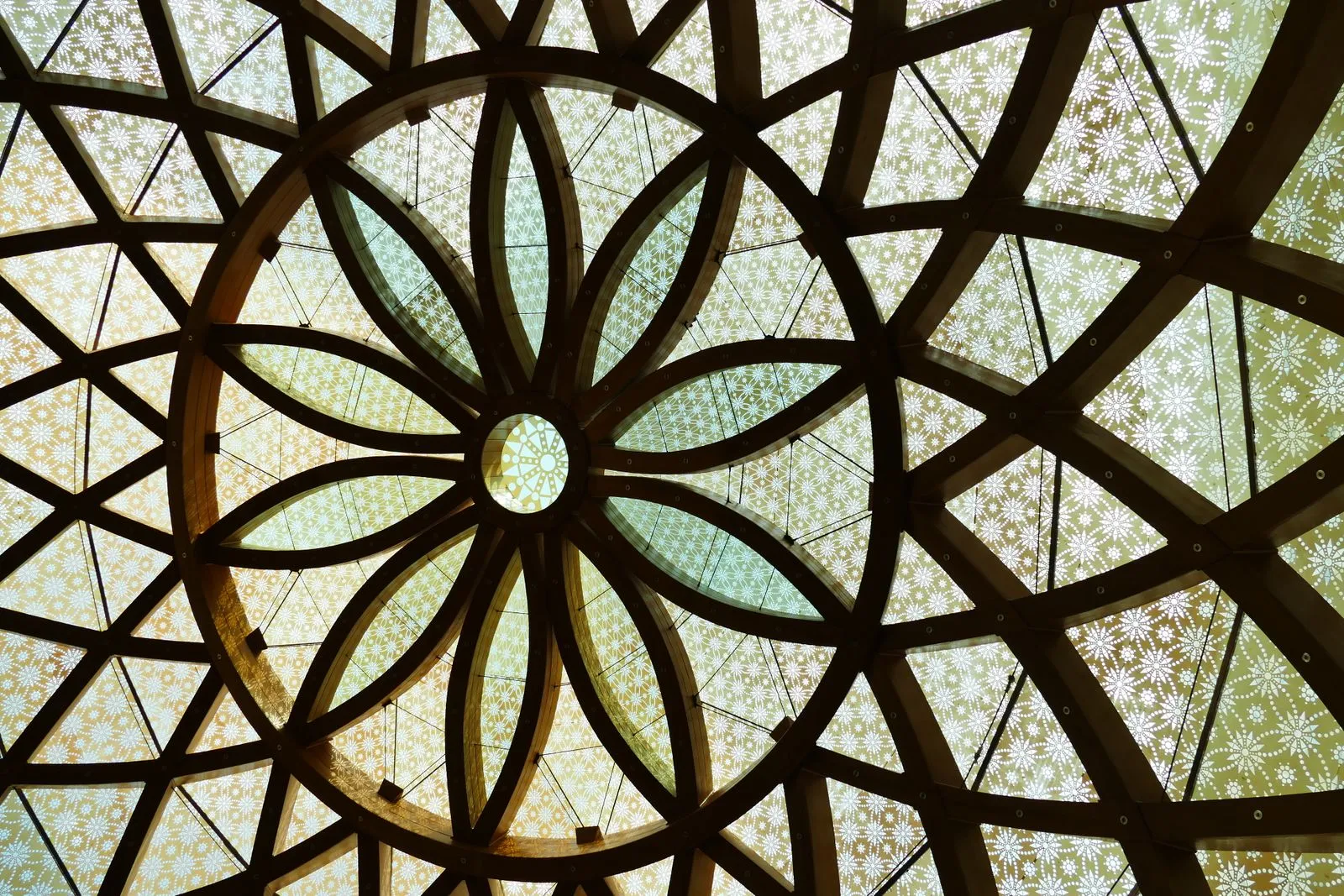 Elegant stained glass dome featuring an intricate floral pattern with geometric design elements.